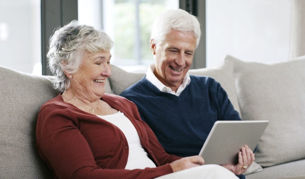 Couple using equity release calculator on tablet