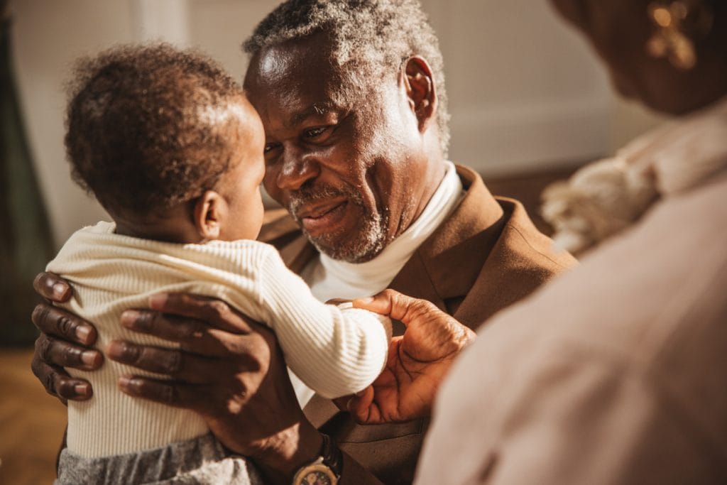 Grandfather holding grandchild