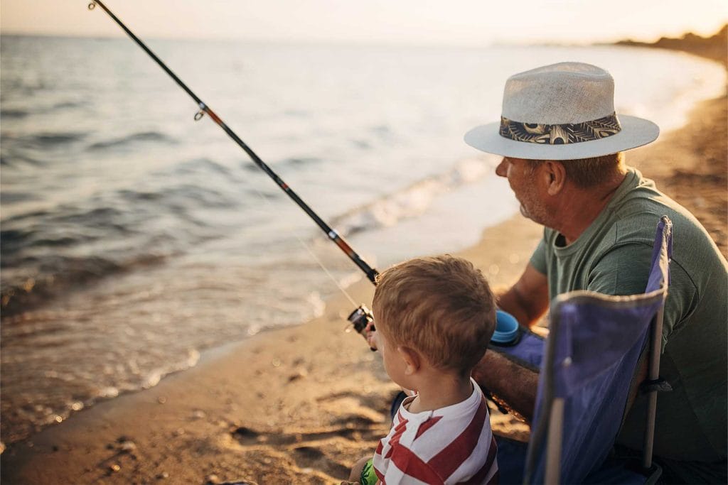 grandfather fishing with his grandson, feeling peaceful after writing his will