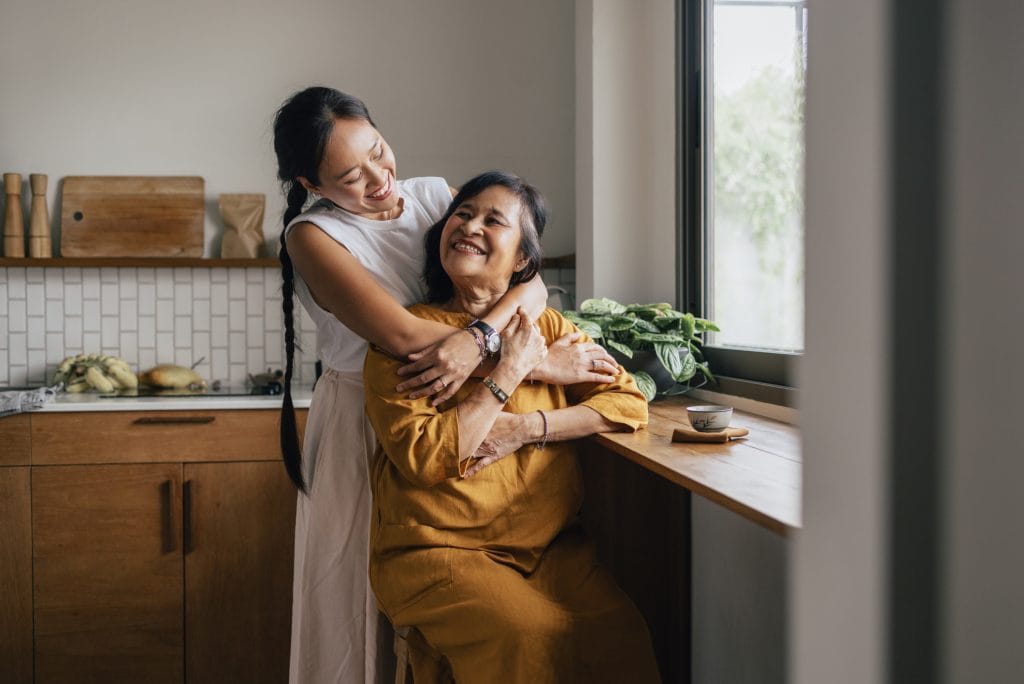 Senior woman embracing her adult daughter, helping her with equity release financially