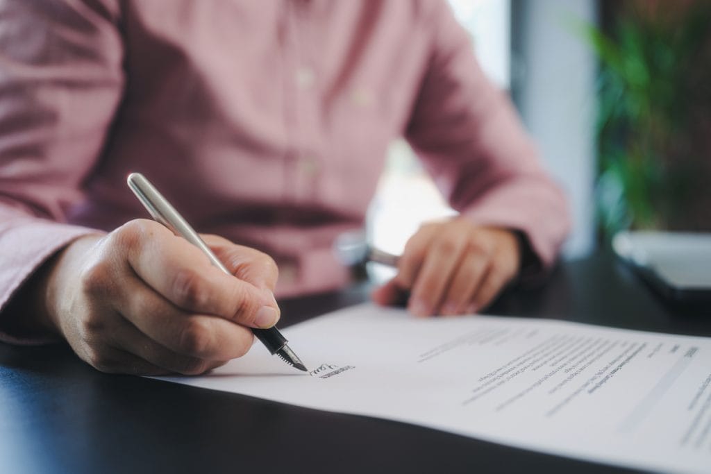 Woman signing her will following advice at bower home finance